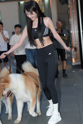 夜拍养狗狗的黑色紧身裤女孩